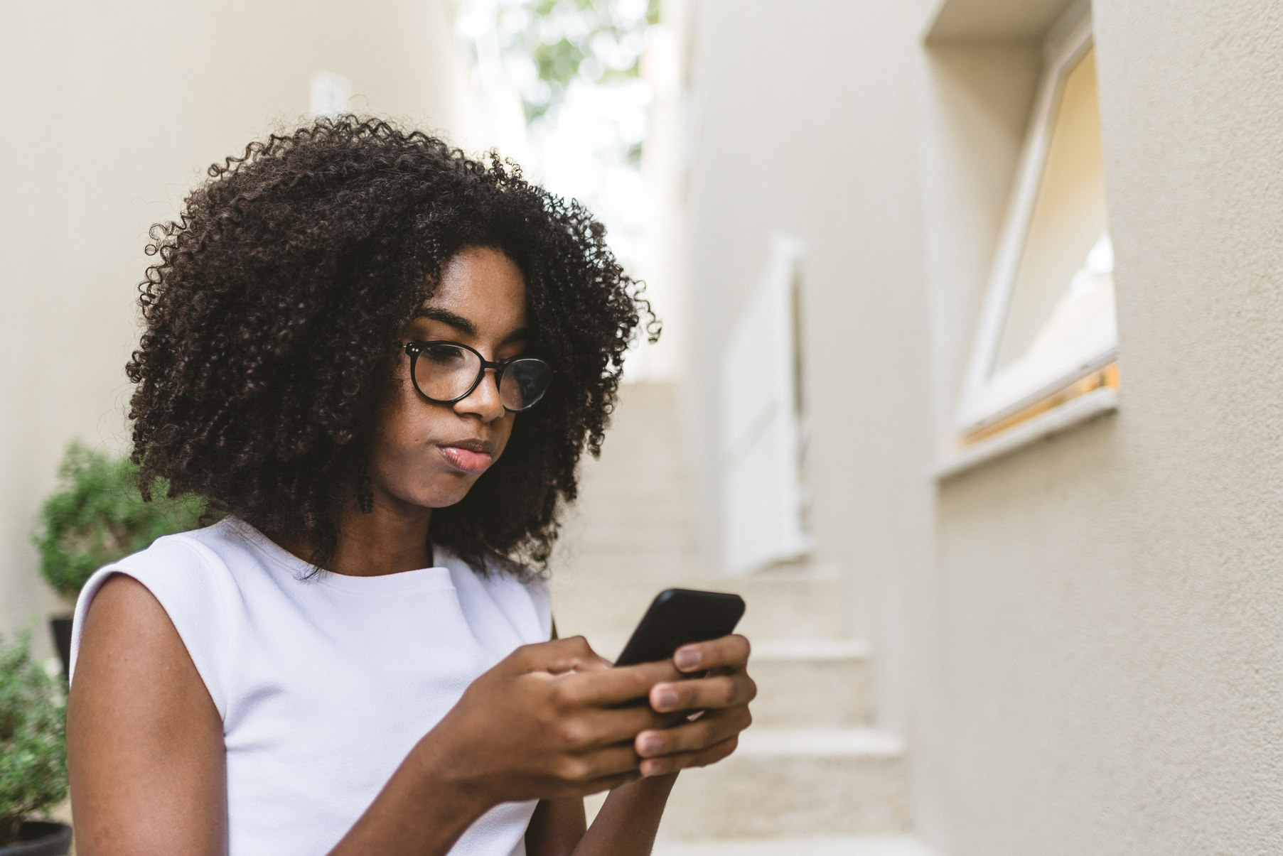 Serious Teen Girl Using Mobile App